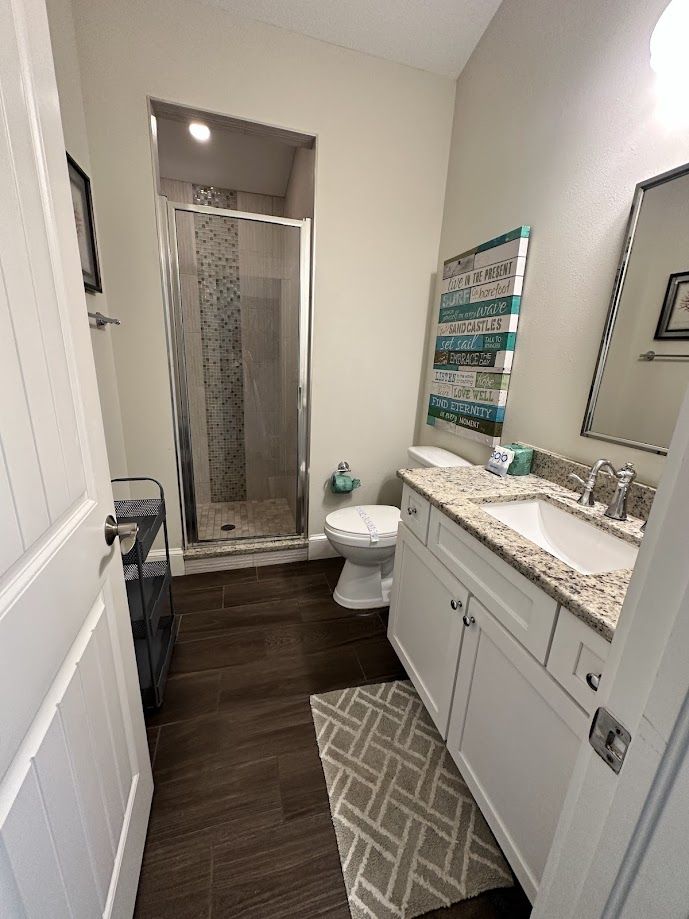 Walk-in glass shower and vanity after a deep clean